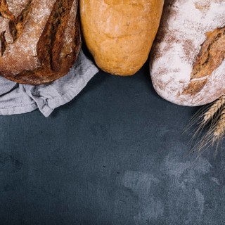 Overhead view rustic loaf breads black counter top
