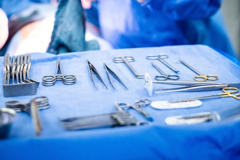 Operating table with surgical cutlery during an operation in a hospital