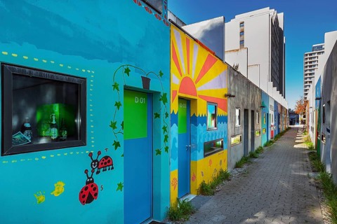 Olympic Village with painting on the former bungalows of the student village