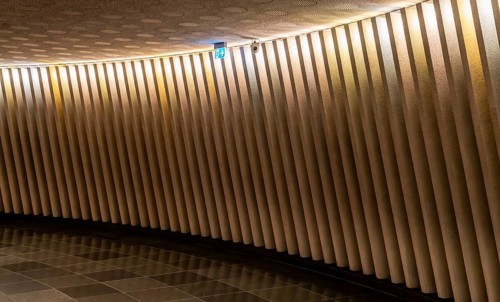 Corridor with concrete wall and a sign indicating the emergency exit