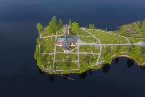 Aerial view over the red wooden Raemmens kyrka