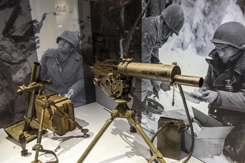 American M1917 Browning machine gun and M2 Mortar in the Bastogne War Museum devoted to the Second World War Two Battle of the Bulge in the Belgian Ardennes