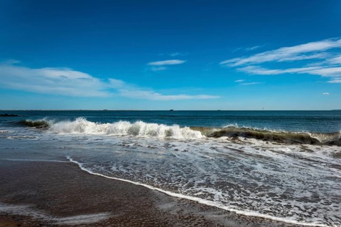 Listening to the ocean waves on a sunny spring day on the Brighton Beach