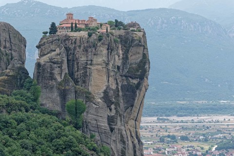 The Meteora Monastery Agia Triada Holy Trinity. The Greek Orthodox Meteora monasteries are built on sandstone cliffs above the Pinios valley. They are a UNESCO World Heritage Site. Kalambaka