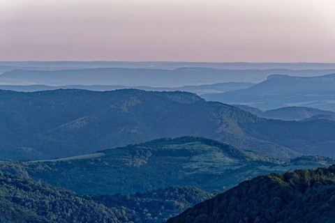 Daybreak over the mountain landscape of the Balkan Mountains and the forested slopes of the Balgarka nature park Park in Central Bulgaria. Shipka