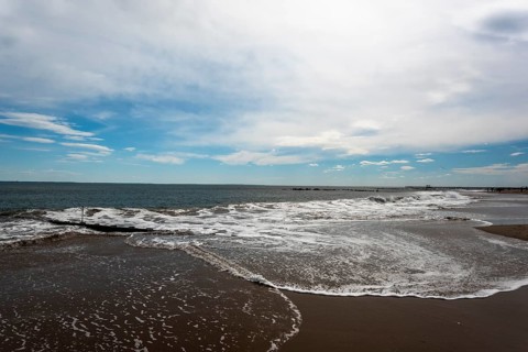 Listening to the ocean waves on a sunny spring day on the Brighton Beach