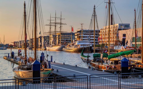 Historic icebreaker Whale and sail training ship Germany in the New Harbour in the evening sun