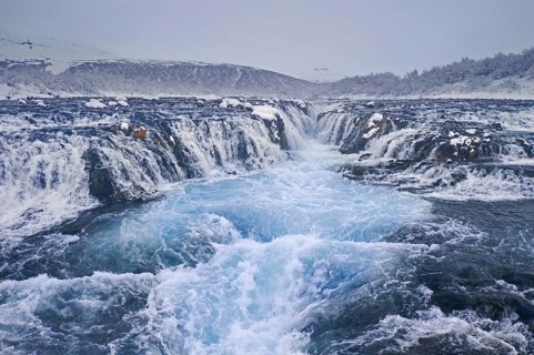 Aerial view over Bruarfoss waterfall in winter