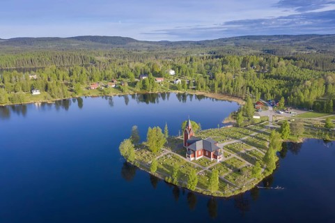 Aerial view over the red wooden Raemmens kyrka