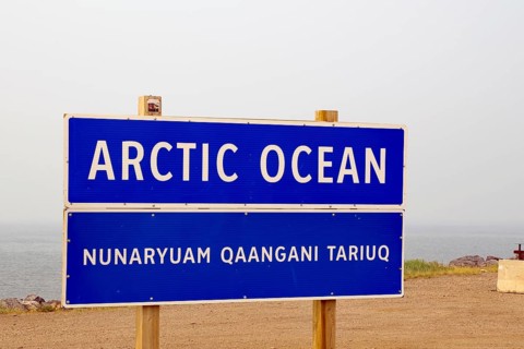 Town sign against overcast background