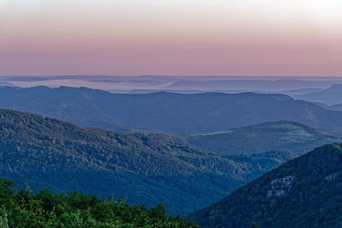 Daybreak over the mountain landscape of the Balkan Mountains and the forested slopes of the Balgarka nature park Park in Central Bulgaria. Shipka