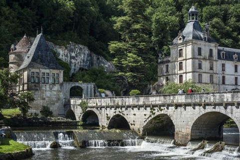 The Benedictine abbey abbaye Saint-Pierre de Brantome and bridge over the river Dronne