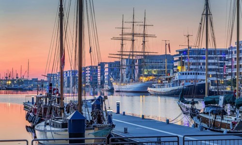 Historic icebreaker Whale and sail training ship Germany in the New Harbour at dusk