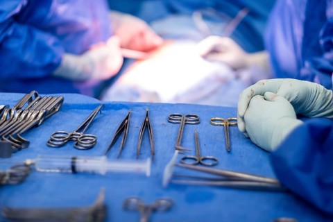 Operating table with surgical cutlery during an operation in a hospital