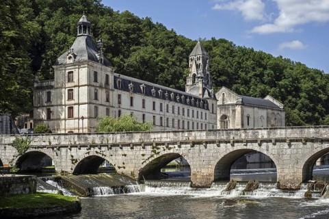 The Benedictine abbey abbaye Saint-Pierre de Brantome and its bell tower along the river Dronne