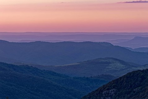 Evening mood over the mountain landscape of the Balkan Mountains and the forested slopes of the Balgarka nature park Park in Central Bulgaria. Shipka