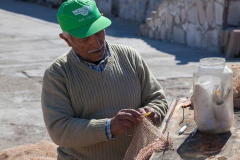 Fishermen mending nets in the Old Port of Antalya