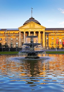 Spa hotel and Casino in late evening light with cascade fountain