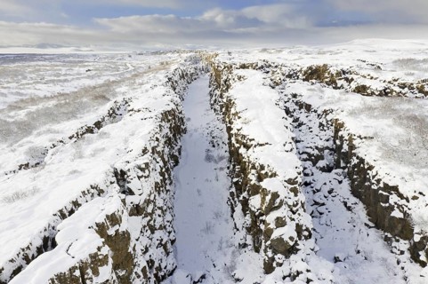 Aerial view over the Almannagja Canyon in the snow in winter