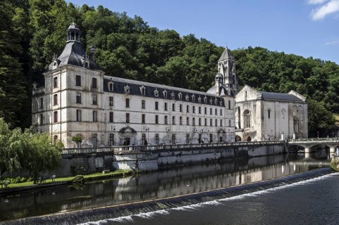 The Benedictine abbey abbaye Saint-Pierre de Brantome and its bell tower along the river Dronne
