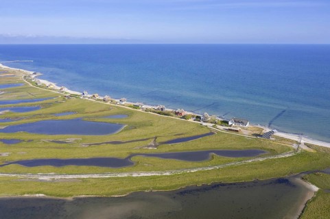 Aerial view over houses on the shore along the Baltic Sea coast at Steinwarder peninsula
