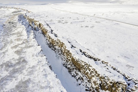 Aerial view over the Almannagja Canyon in the snow in winter