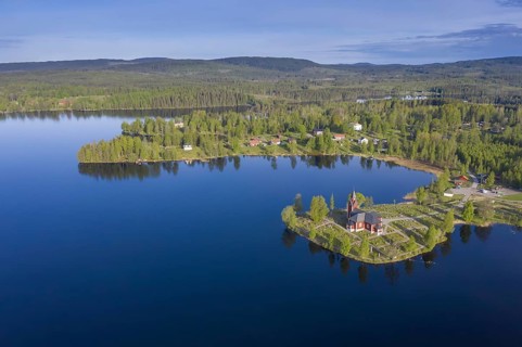 Aerial view over the red wooden Raemmens kyrka