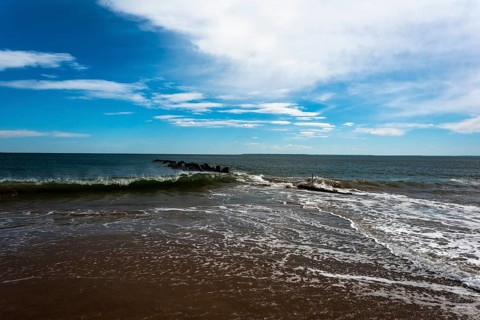 Listening to the ocean waves on a sunny spring day on the Brighton Beach