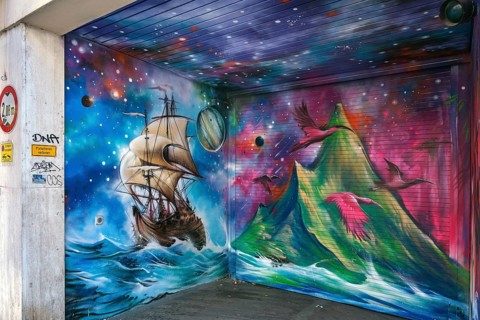 Graffiti with antique sailing ship and volcano on garage entrance