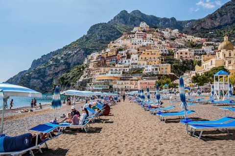Beach with beach chairs and view of the village
