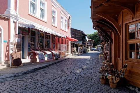 Half-timbered houses with wooden tops and roof overhangs typical of the locality on the cobbled street in the old town. Sozopol