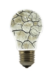 Cracked earth by drought inside incandescent lamp