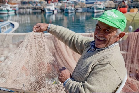Fishermen mending nets in the Old Port of Antalya