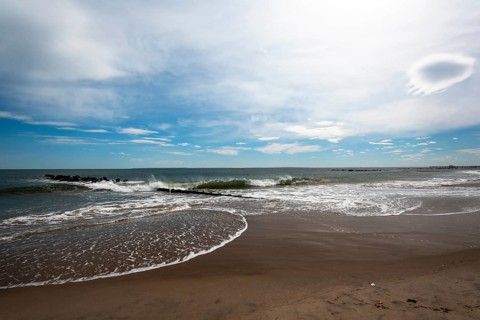 Listening to the ocean waves on a sunny spring day on the Brighton Beach