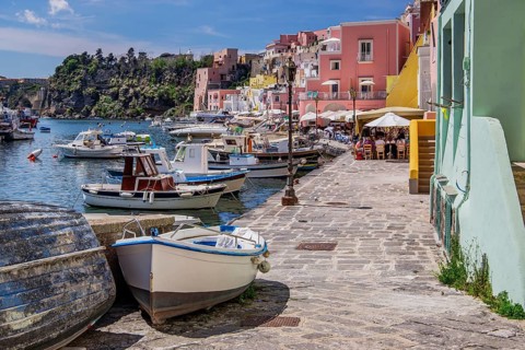 Shore path with fishing boats and fishing harbour of the fishing village Corricella