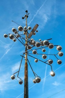 Pole of a street light as a work of art with disco balls