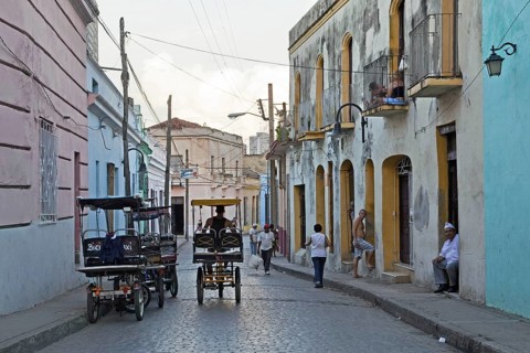 Street scene showing three-wheeled bicycle taxis in the city Camagueey
