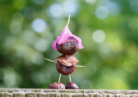 Funny chestnut figure with blossom on head