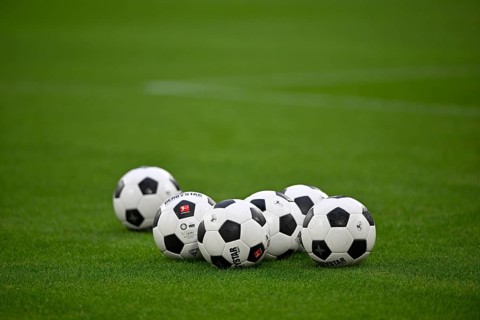Adidas Derbystar match balls lie on grass