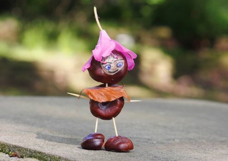 Funny chestnut figure with blossom on head