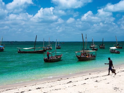 Boats on the white beach in the turquoise sea