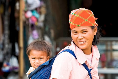 Mother carrying child in sling