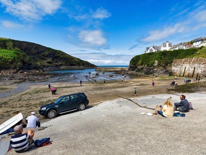 Pedestrians in the harbour at low tide