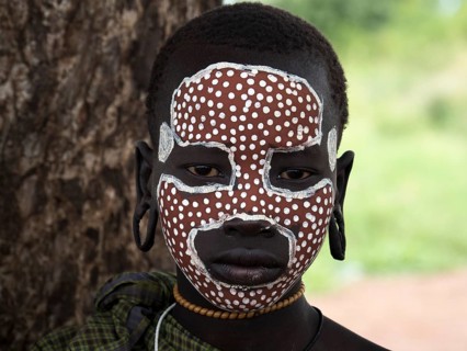 Girl from the Mursi tribe with face painting