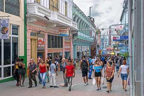Streetscene showing shops and Cuban shoppers in shopping street in Santiago de Cuba