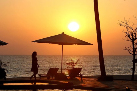 Parasol and woman in evening sun