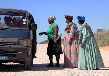 Herero woman in front of a shared taxi
