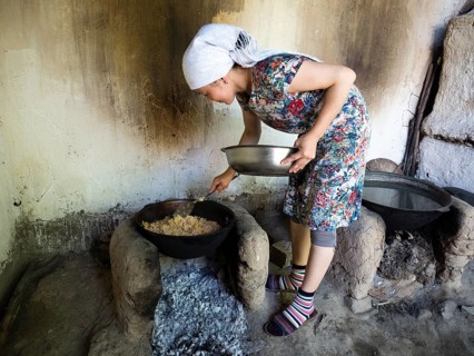 Young woman preparing rice dish Plov