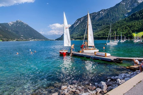 Jetty on the lake promenade with sailing boats