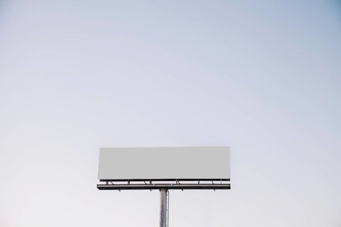 White blank billboard against blue sky